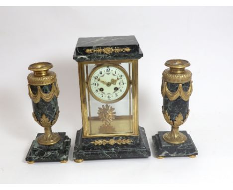 A French verde antico and ormolu mounted clock garniture, circa 1900, the white enamel dial with Roman numerals and painted w