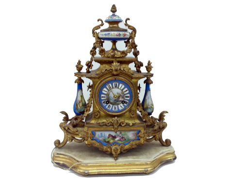 R & Co:  A French gilt metal and porcelain mounted mantel clock, circa 1870, the foliate cast case surmounted by a classical 