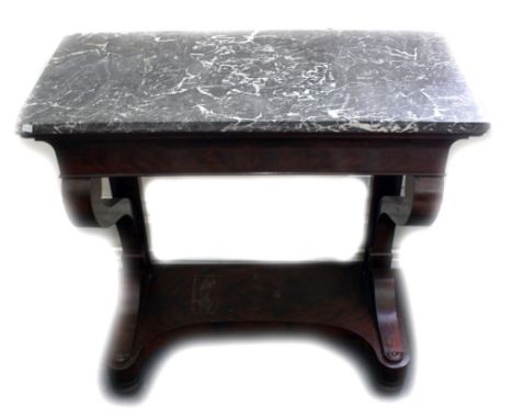 A Louis Phillipe mahogany console table, with rectangular grey veined marble top, on scroll supports, the concave sided platf