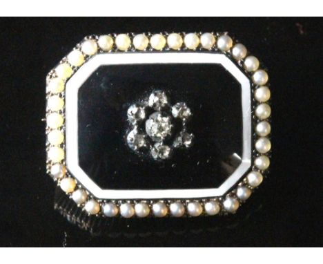 A Victorian diamond, pearl and enamel brooch, of canted rectangular outline, centred by a seven stone cluster of old and rose