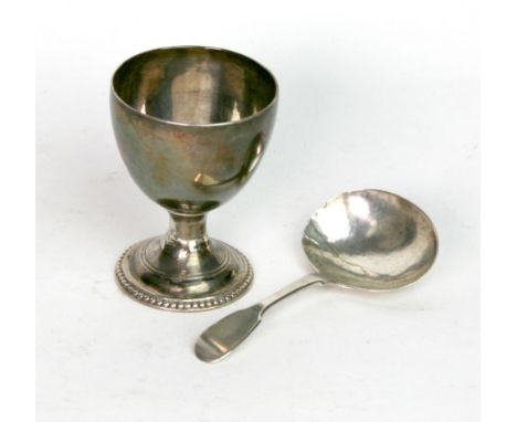 A George III silver egg cup, marks rubbed, probably London 1775, with beaded circular base, 6.5cm, monogrammed and a George I