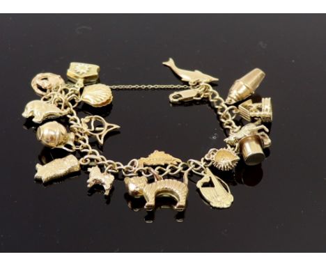 A 9ct gold curb link 'charm' bracelet hung with 17 various charms including a kangaroo and opal-doublet, a cocktail shaker, a