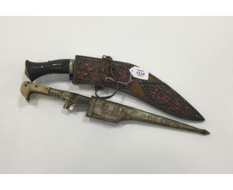 A LATE 19TH/EARLY 20TH CENTURY GHURKHA KUKRI, with a silver mounted and velvet scabbard decorated with figures, animals and f