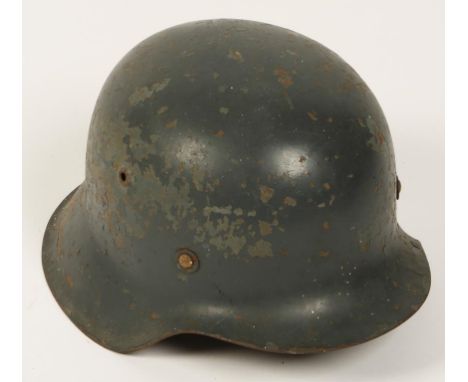 A GERMAN NAZI HELMET, probably with the original lining, and replacement chin strap.