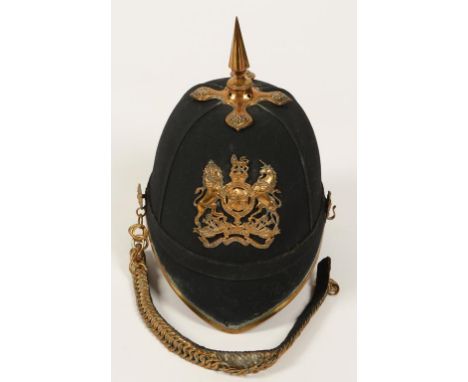 AN EARLY 20TH CENTURY ROAYL ENGINEERS HOME SERVICE HELMET, blue cloth with brass lining, regimental badge, chain and spike.