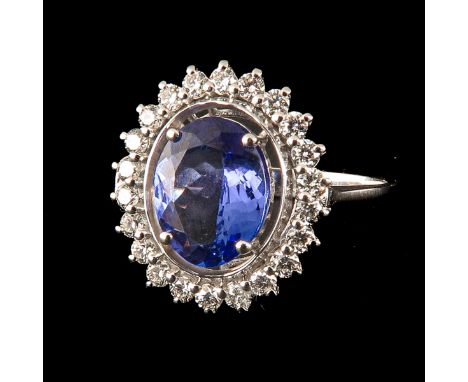 With oval cut tanzanite 2 Ct. surrounded by 22 brilliant cut diamonds total 0.5 Ct. ring size 17