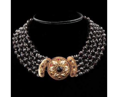 with 5 rows of faceted garnet in 14 KG clasp worn in the Walcheren regional costume clasp diameter 36 mm diameter beads 7 - 8