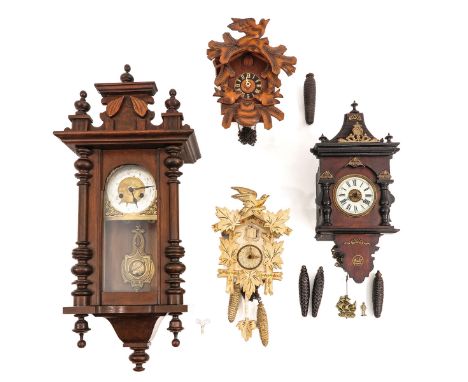 consisting of 4 wall clocks, including a white painted cuckoo clock, height 84 cm.