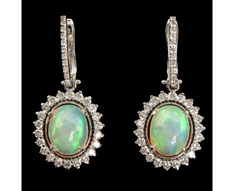 Each set with cabochon cut opal each weighing over 2 Ct surrounded by a total of 64 diamonds totaling 1.25 Ct. G/VS/SI