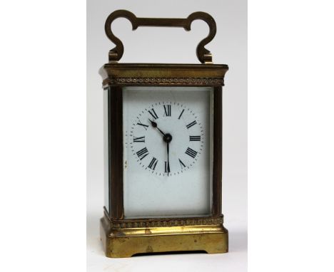 Five glass brass carriage clock with black Roman numerals on a white face approx height not including handle 12cm (key includ