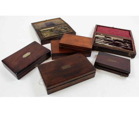 Seven drawing / compass sets, each in mahogany box, containing numerous compasses