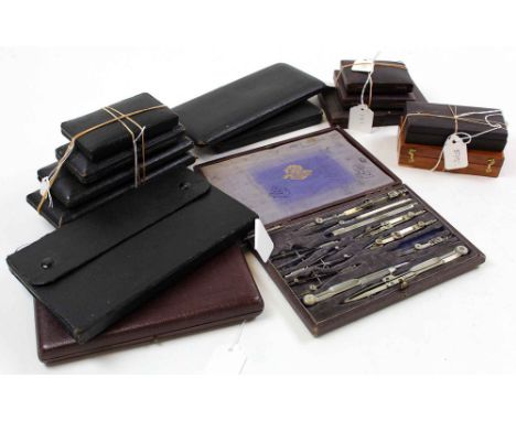 Fifteen compass sets, all in cases (mostly leather)