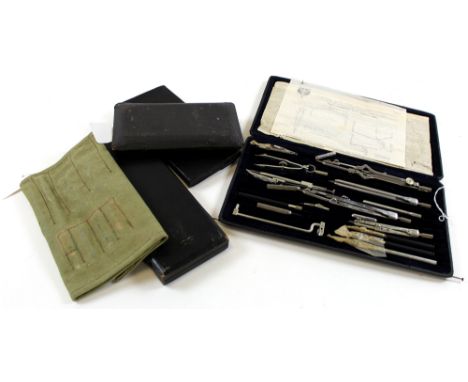Twelve compass sets, all in cases (mostly leather)