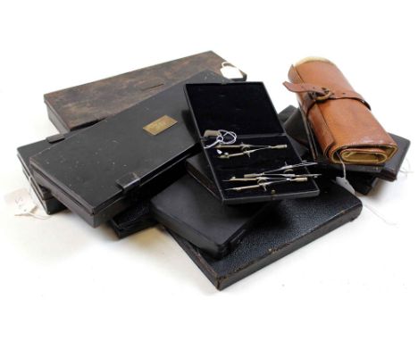Twelve compass sets, all in cases (leather / tins)