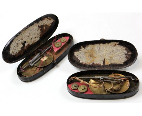 Coin scales. Two similar sets of coin scales, circa late 19th century, each with two weights, both in metal cases