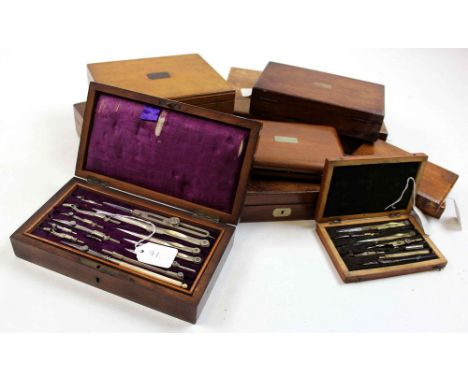 Nine drawing / compass sets, each in mixed wood box (including walnut and oak), containing numerous compasses