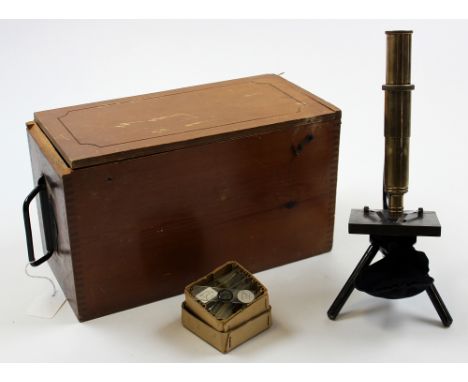 Small early 20th century cast iron and brass microscope by Luxima, in fitted wooden case.