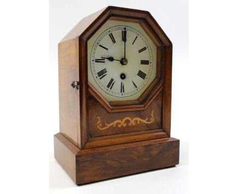 Small 19th century american made mantle clock with walnut veneer and painted enamel face decorated with roman numerals. 26 cm