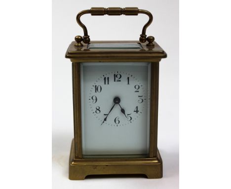Brass framed five glass carriage clock with black Arabic numerals on a white face Approx height 11cm (not including handle)