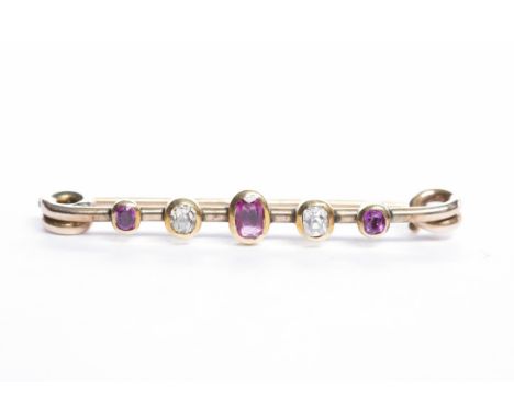 EARLY TWENTIETH CENTURY RUBY AND DIAMOND BAR BROOCH set with three oval rubies interspaced by two diamonds, 38mm long, unmark