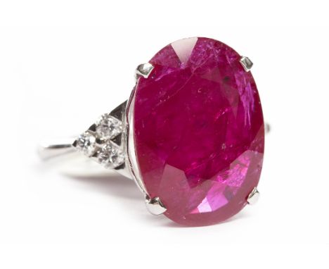IMPRESSIVE RUBY AND DIAMOND RINGthe central oval ruby 17x12.5mm on diamond set shoulders, in eighteen carat white gold, size 