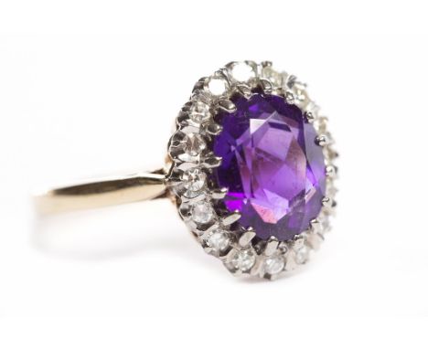 NINE CARAT GOLD AMETHYST AND DIAMOND RINGthe central oval amethyst surrounded by diamonds, in eighteen carat gold