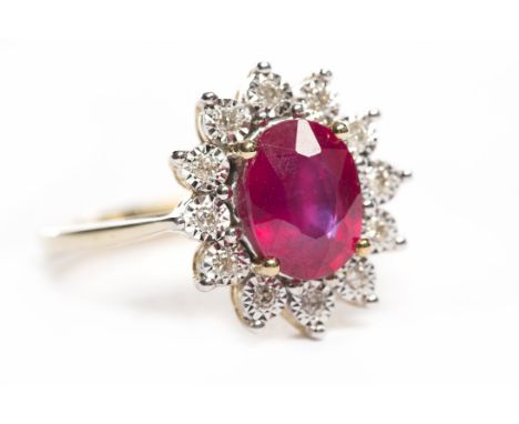 NINE CARAT GOLD RUBY AND DIAMOND RINGthe central oval ruby surrounded by illusion set diamonds, size N