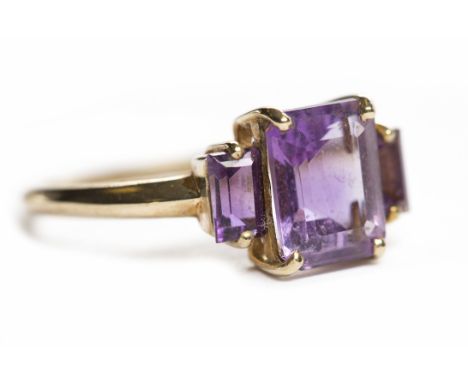 AMETHYST THREE STONE RINGset with graduated emerald cut amethysts, unmarked