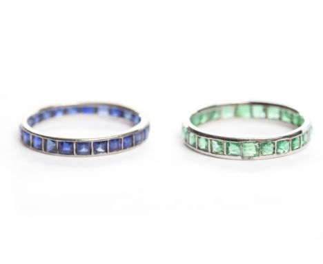 PAIR OF ETERNITY RINGSboth twentieth century, one set with sapphires, the other with emeralds, both unmarked, the emerald exa