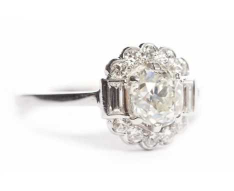 EARLY TWENTIETH CENTURY DIAMOND RINGset with an earlier old cushion cut diamond of approximately 0.90 carats flanked by two b