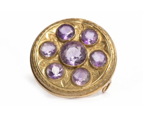 VICTORIAN AMETHYST TARGE STYLE BROOCHof circular form, engraved and set with seven round amethysts, 22mm across, unmarked, 4.