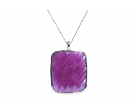 IMPRESSIVE RUBY PENDANTthe rectangular ruby with faceted table approximately 20x16mm, in eighteen carat gold, on a nine carat
