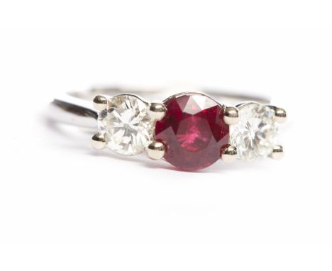 RUBY AND DIAMOND THREE STONE RINGthe central round ruby of approximately 1.24 carats flanked by two round diamonds totalling 