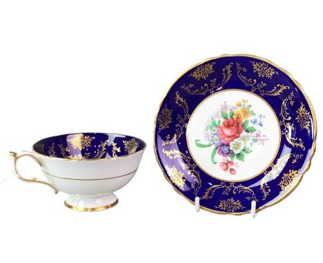 PARAGON CUP AND SAUCER, with floral and gilt decoration and blue cobalt border