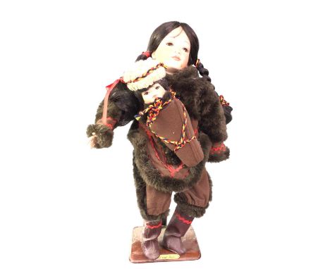 ALASKAN INUIT DOLL, AND A COLLECTION OF PORCELAIN FIGURES  the doll on a standthe Inuit doll 45cm tall