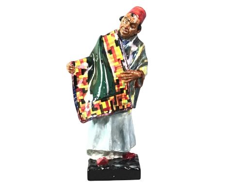 FOUR ROYAL DOULTON FIGURES, comprising the Carpet Seller, HN1464, Old Mother Hubbard, HN2314, The Puppet Maker, HN2253 and Th