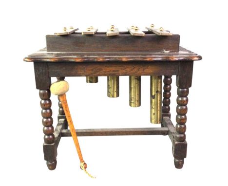 VINTAGE TABLE TOP XYLOPHONE, with brass keys and beater, on oak bobbin legs30cm high