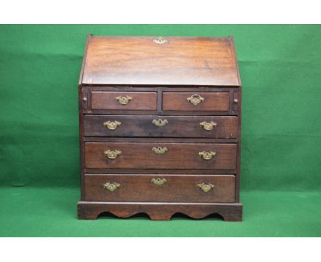 Georgian oak bureau having fall front opening to reveal fitted interior over two short and three long drawers with brass hand