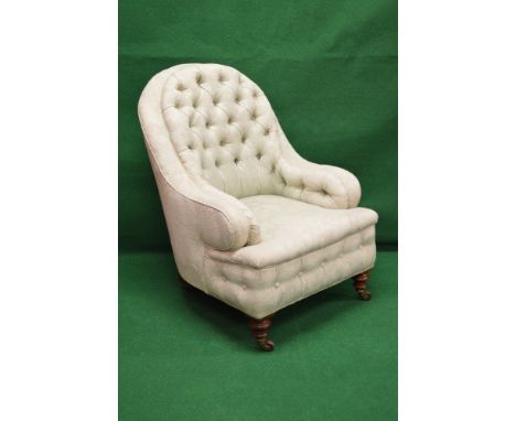 Victorian button back nursing armchair having buttoned and padded back and arms over padded seat, standing on turned legs end