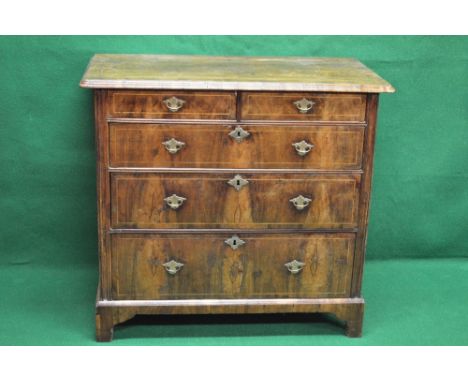 19th century walnut chest of drawers having cross banded top and moulded edge over two short and three long graduated drawers