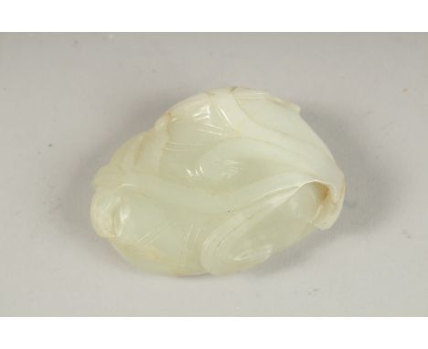 A GOOD CHINESE TWO-COLOUR CARVED JADE LILY PAD, 6cm x 4cm.