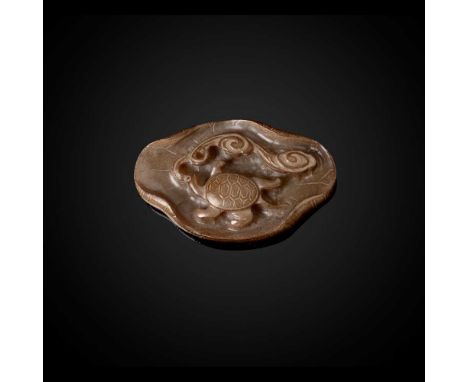 WHITE JADE WITH INCLUSIONS 'TORTOISE ON LOTUS LEAF' HAT FINIAL YUAN DYNASTY 元 白玉帶沁和龜同壽帽頂飾 in the form of a large lotus leaf, 