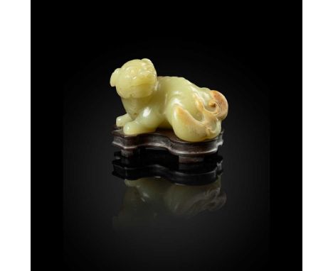 YELLOW JADE WITH RUSSET SKIN CARVING OF A LION DOG QING DYNASTY, 18TH CENTURY  清 黃玉帶皮雕祥獅擺件 carved in the round with a lion do