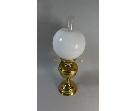 A Brass Oil Lamp with Opaque Globe Shade 