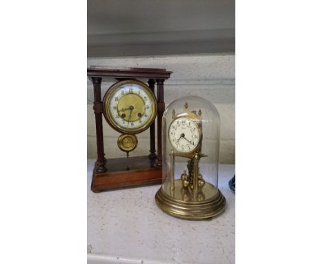 A late 19th century open mahogany framed four column mantle clock together with a Kundo brass Anniversary clock under glass d
