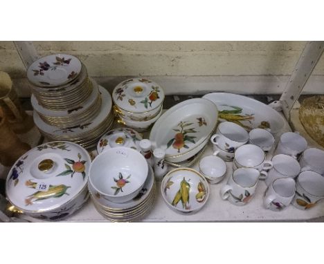 A shelf containing the residue of a large Royal Worcester porcelain dinner and tea service decorated in the Evesham and simil