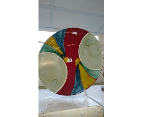 A Poole Pottery Living Glaze charger decorated in the Aurora pattern designed by Alan Clarke painted by Nicky Massarella.