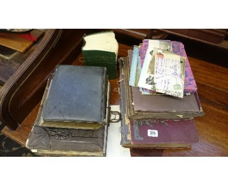 An early 20th century postcard album and contents containing interesting local and other postcards together with another, loo