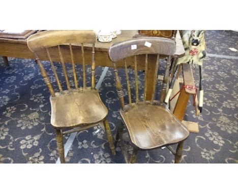 A pair of elm framed stick back kitchen dining chairs.