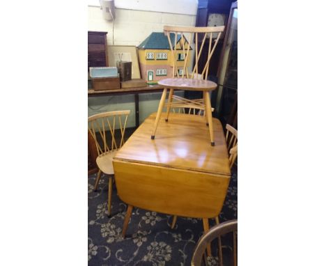 A mid 20th century Ercol Windsor drop-leaf dining table together with a set of four beech dining chairs.